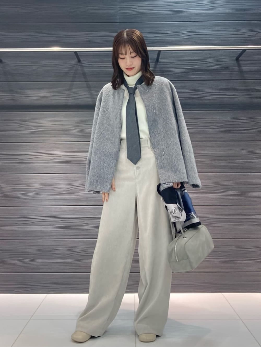 ベージュ系のその他パンツ、グレー系のその他アウター、ブラック系のストール/ショールを着用したレディースの冬コーディネートの3枚目の写真