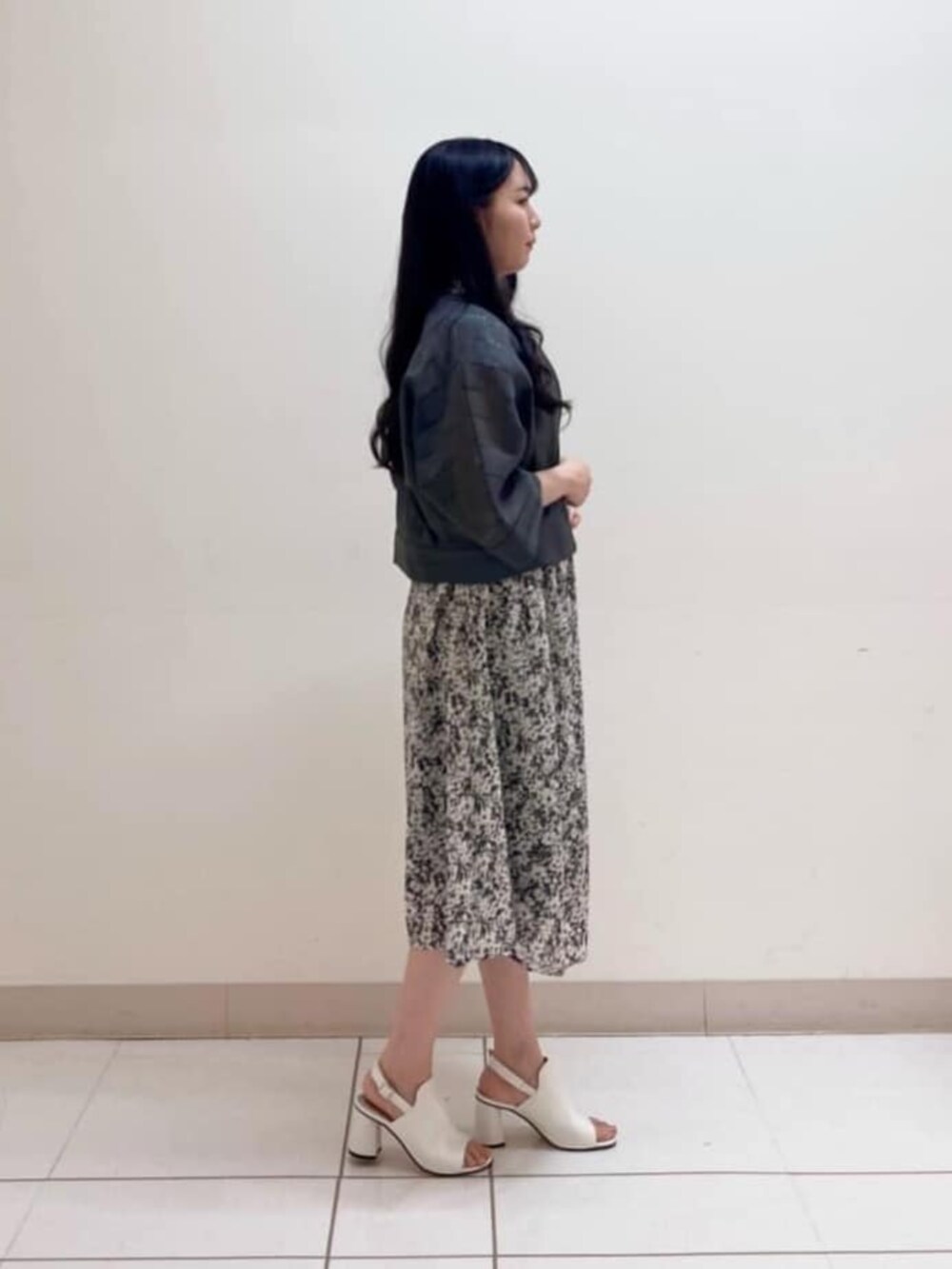 ホワイト系のサンダル、グレー系のワンピースを着用したレディースの夏コーディネートの2枚目の写真