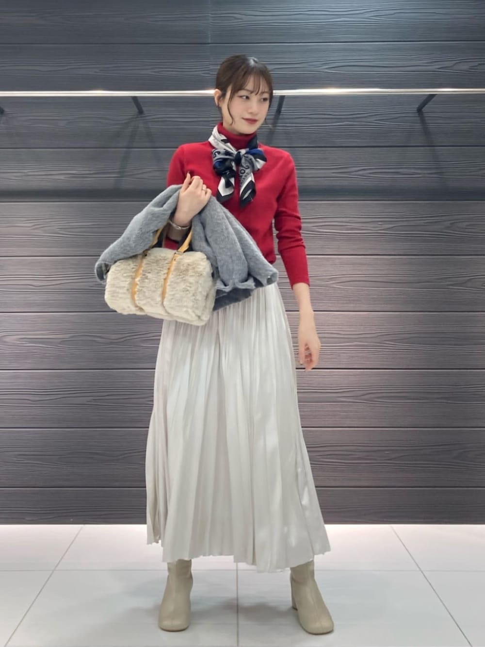 ホワイト系のブーツ、ホワイト系のスカート、グレー系のその他アウターを着用したレディースの冬コーディネートの4枚目の写真