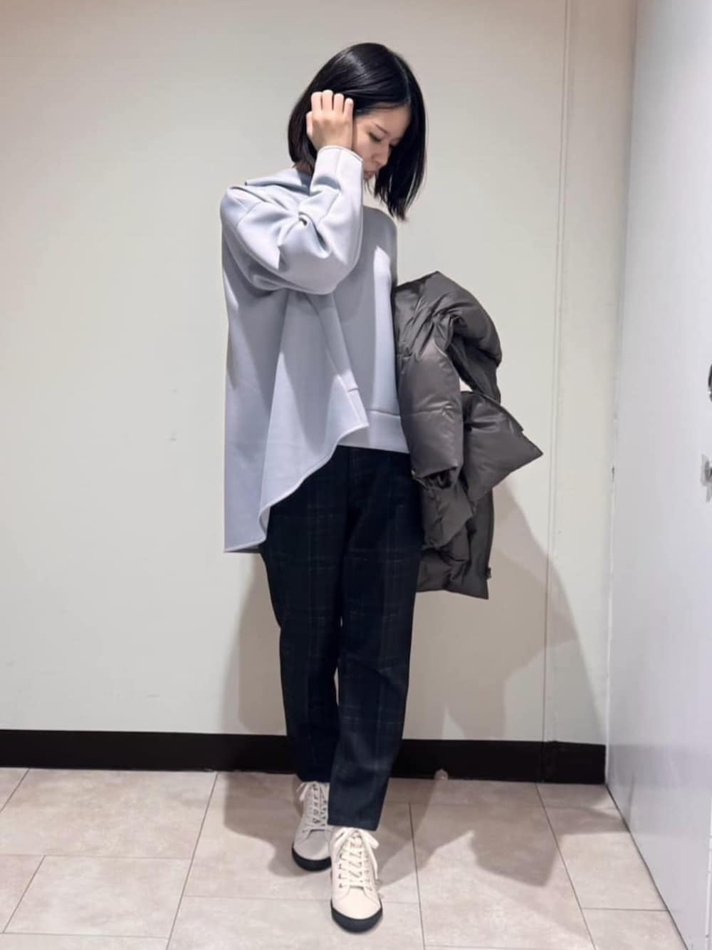 グレー系のダウンジャケット/コート、ブラウン系のその他パンツ、ブルー系のパーカーを着用したレディースの冬コーディネートの5枚目の写真