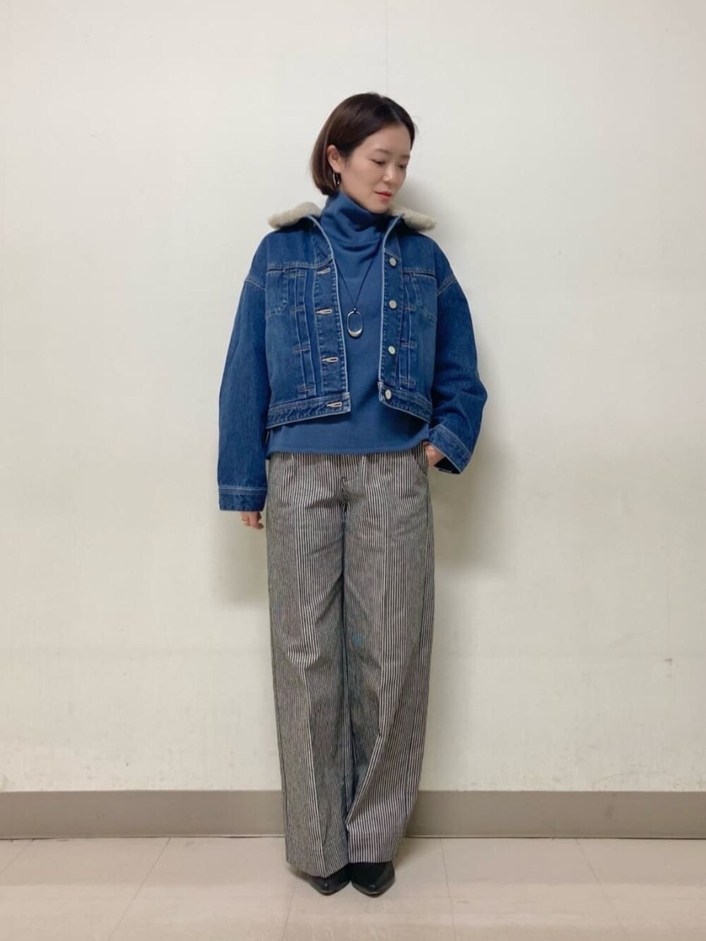 ブルー系のデニムジャケット、ブルー系のTシャツ/カットソーを着用したレディースの冬コーディネートの2枚目の写真