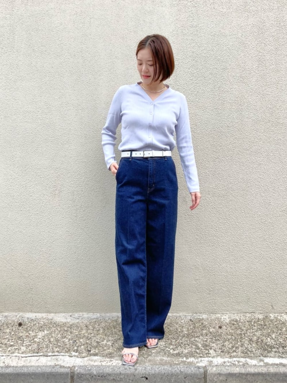 ブルー系のデニムパンツ、パープル系のカーディガン/ボレロ、ホワイト系のベルトを着用したレディースの夏コーディネートの2枚目の写真