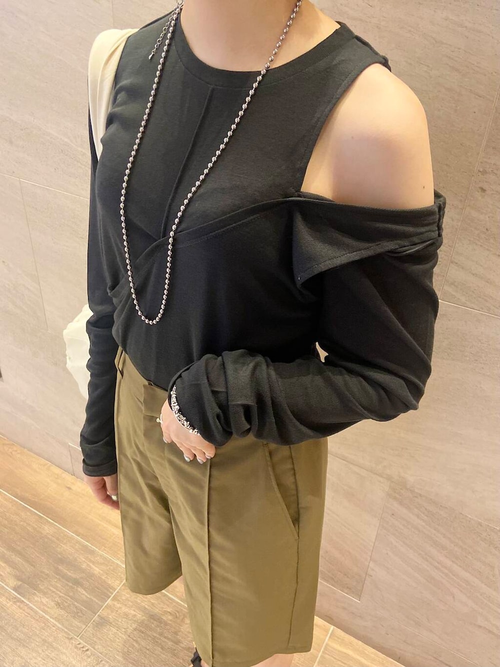 ベージュ系のスニーカー、グリーン系のその他パンツ、ホワイト系のショルダーバッグを着用したレディースの夏コーディネートの4枚目の写真