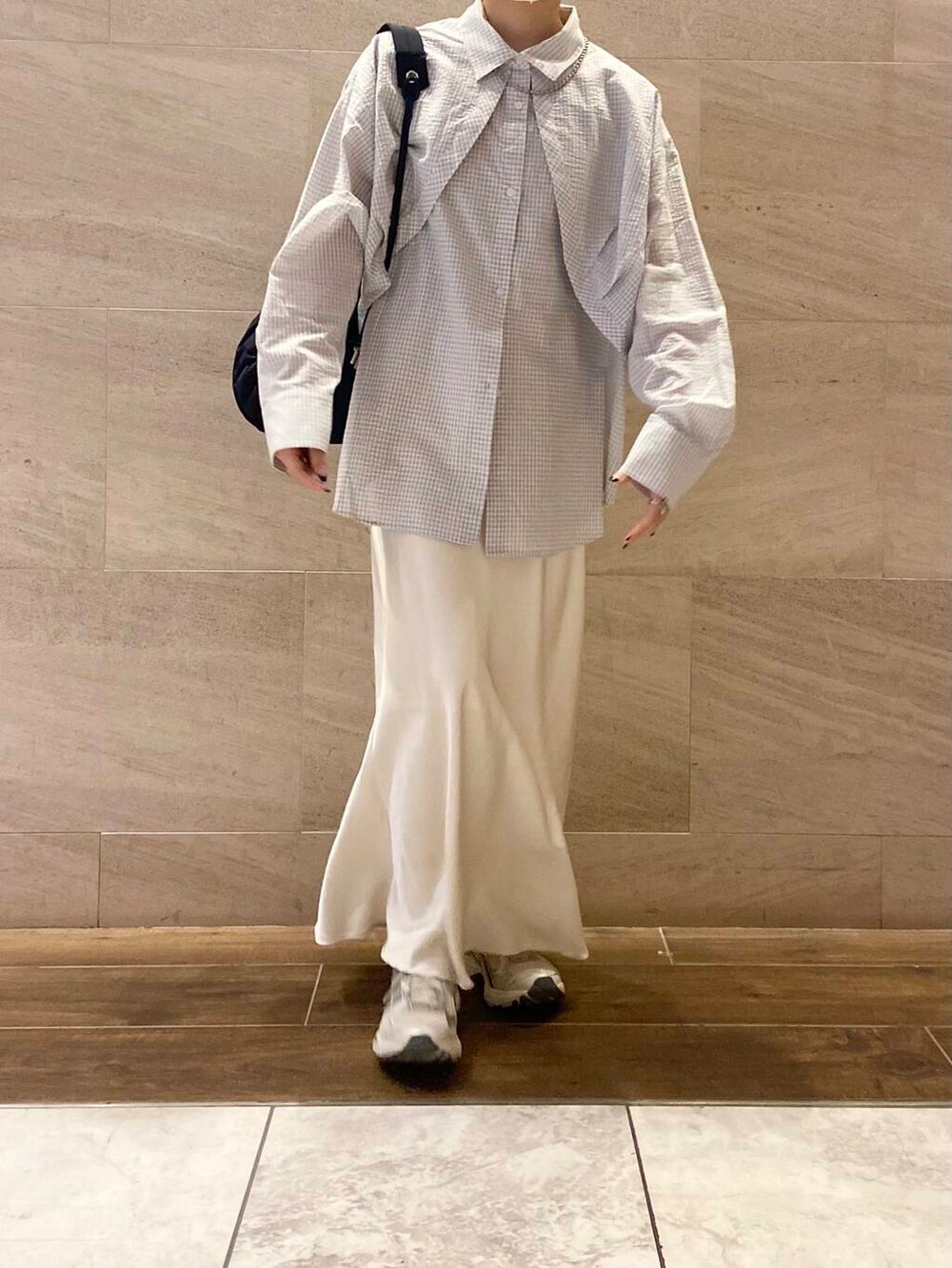 ホワイト系のスカート、ブルー系のショルダーバッグ、ホワイト系のシャツ/ブラウスを着用したレディースの冬コーディネートの5枚目の写真