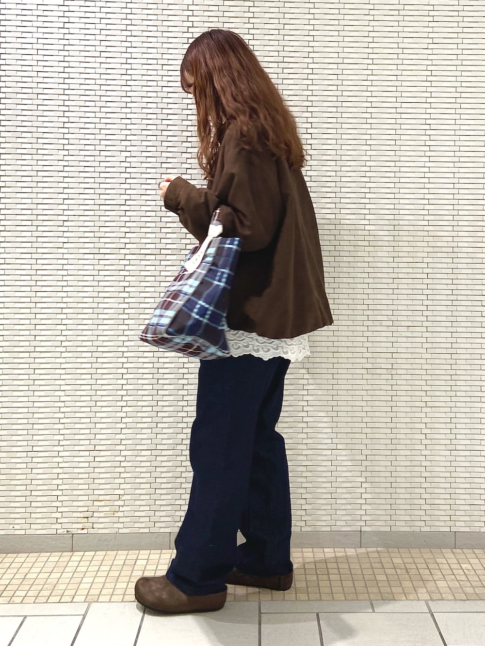 ホワイト系のシャツ/ブラウス、ブラウン系のブルゾン、ブラウン系のトートバッグを着用したレディースの秋コーディネートの3枚目の写真