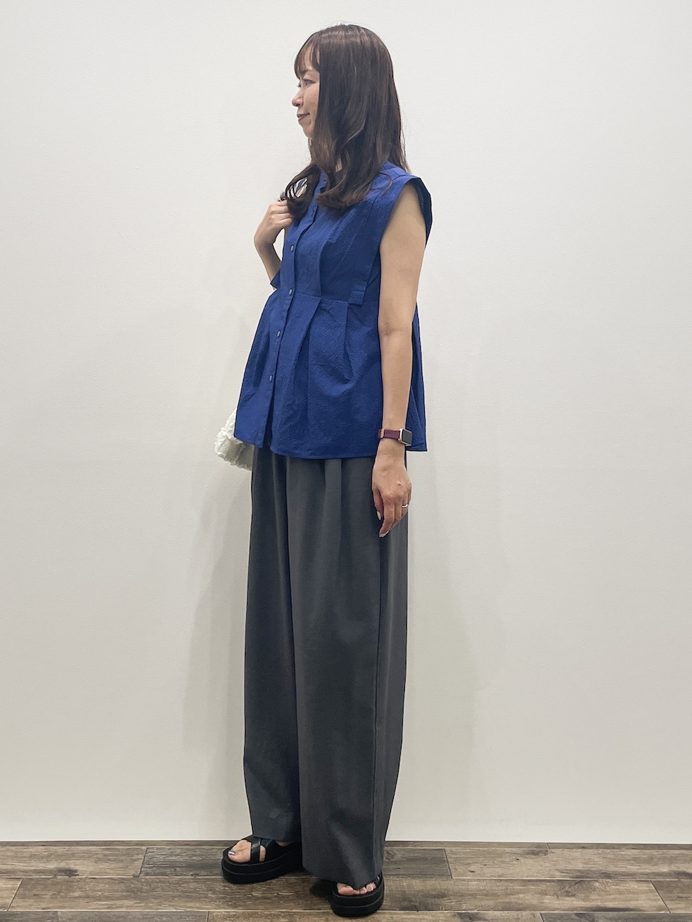 ブルー系のシャツ/ブラウス、グレー系のその他パンツ、ホワイト系のトートバッグを着用したレディースの夏コーディネートの3枚目の写真