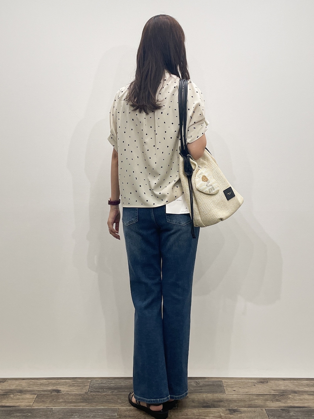 ベージュ系のシャツ/ブラウス、ブルー系のデニムパンツ、ホワイト系のトートバッグを着用したレディースの夏コーディネートの6枚目の写真