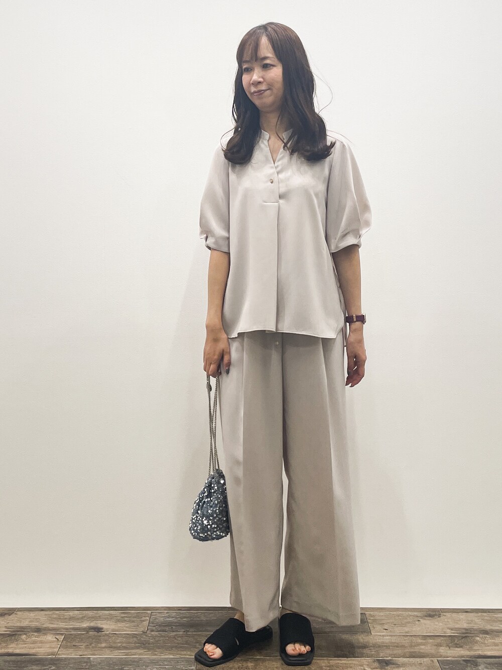 ベージュ系のシャツ/ブラウス、ベージュ系のその他パンツ、グレー系のショルダーバッグを着用したレディースの春コーディネートの2枚目の写真