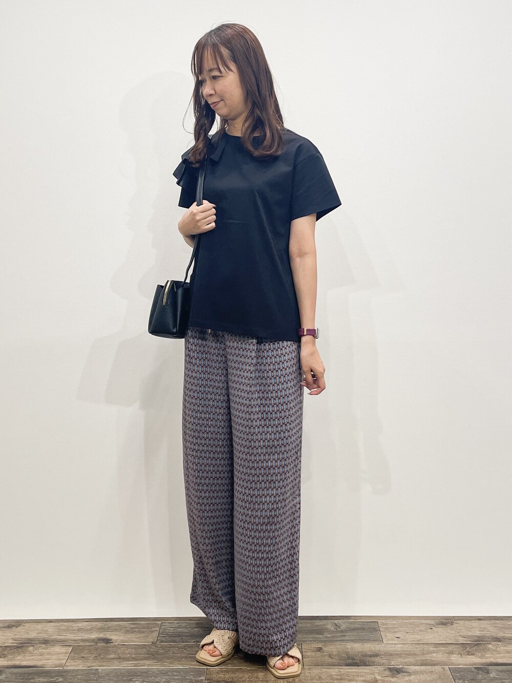 ブラック系のTシャツ/カットソー、ブラウン系のその他パンツ、ブラック系のショルダーバッグを着用したレディースの夏コーディネートの2枚目の写真