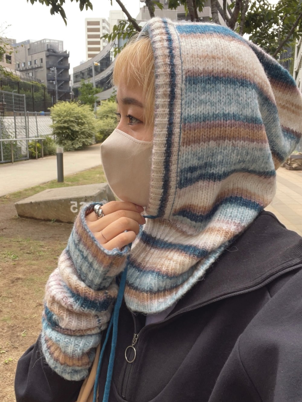 ベージュ系のショルダーバッグ、ブルー系のニット/セーターを着用したレディースの秋コーディネートの5枚目の写真