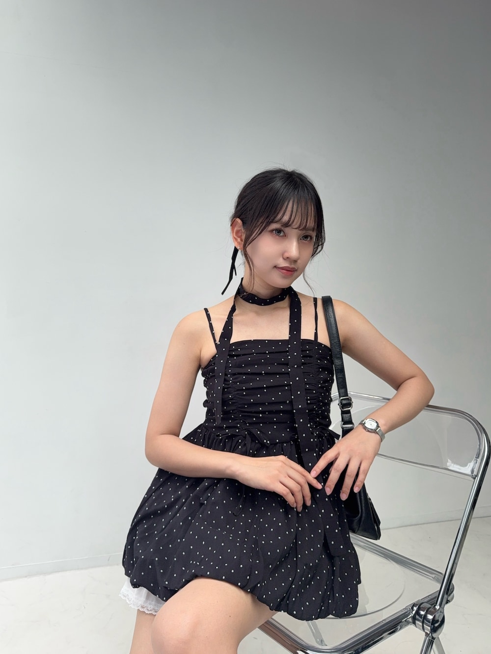 ブラック系のチュニック、ホワイト系のスカート、ブラック系のサンダルを着用したレディースの夏コーディネートの7枚目の写真