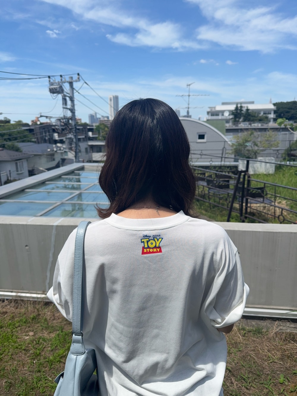 ホワイト系のTシャツ/カットソー、ブラック系のスカート、ブラック系のサンダルを着用したレディースの夏コーディネートの5枚目の写真