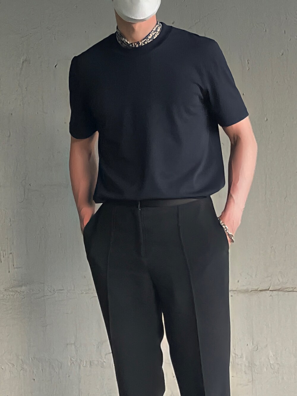 ホワイト系のTシャツ/カットソー、ブラック系のスラックス、シルバー系のブレスレットを着用したメンズの夏コーディネートの2枚目の写真