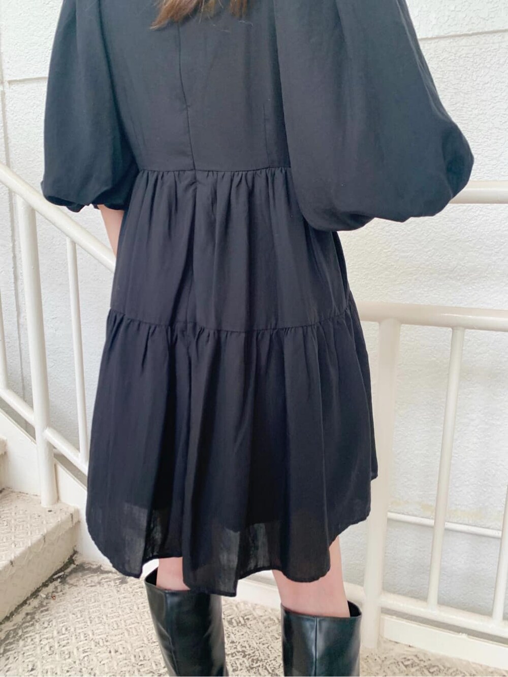 ブラック系のワンピース、ブラック系のブーツ、ブラック系のハットを着用したレディースの秋コーディネートの4枚目の写真