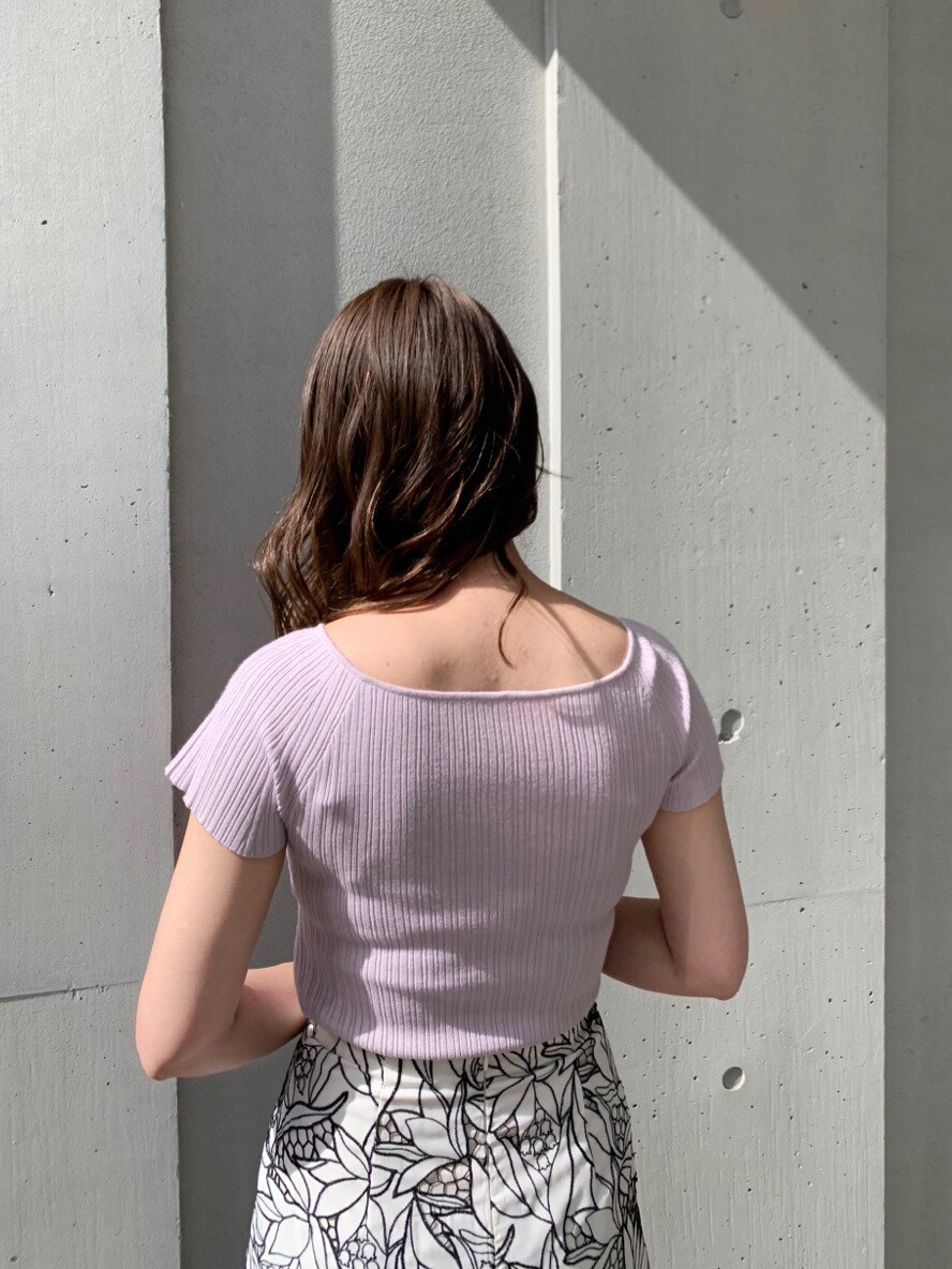 ブラック系のスカート、ホワイト系のサンダル、パープル系のニット/セーターを着用したレディースの春コーディネートの3枚目の写真