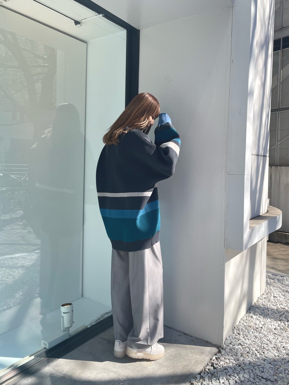 グレー系のカーディガン/ボレロ、ブラック系のニット/セーター、グレー系のスラックスを着用したレディースの冬コーディネートの4枚目の写真