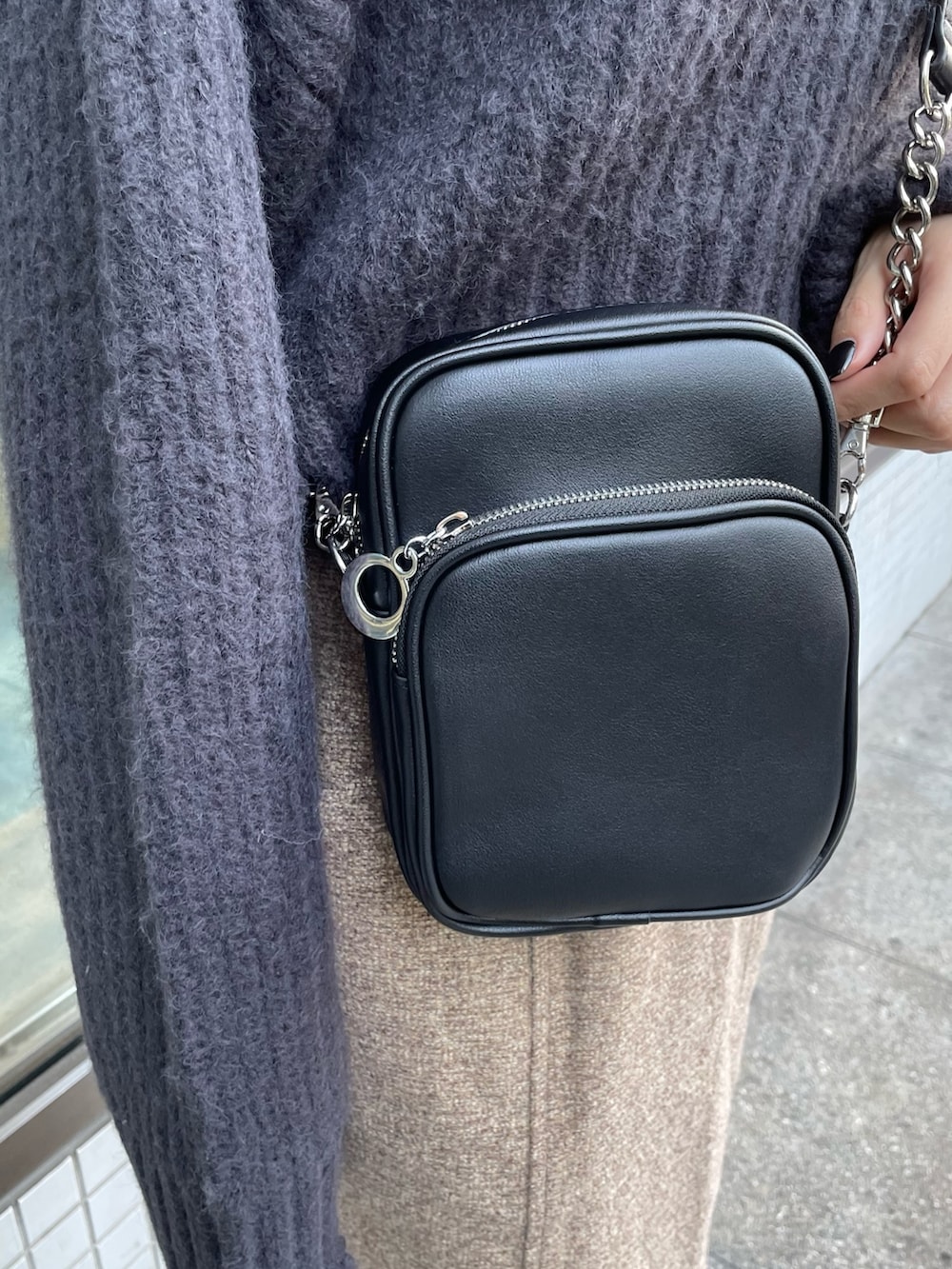 グレー系のニット/セーター、ブラウン系のスカート、ブラック系のブーツを着用したレディースの秋コーディネートの7枚目の写真