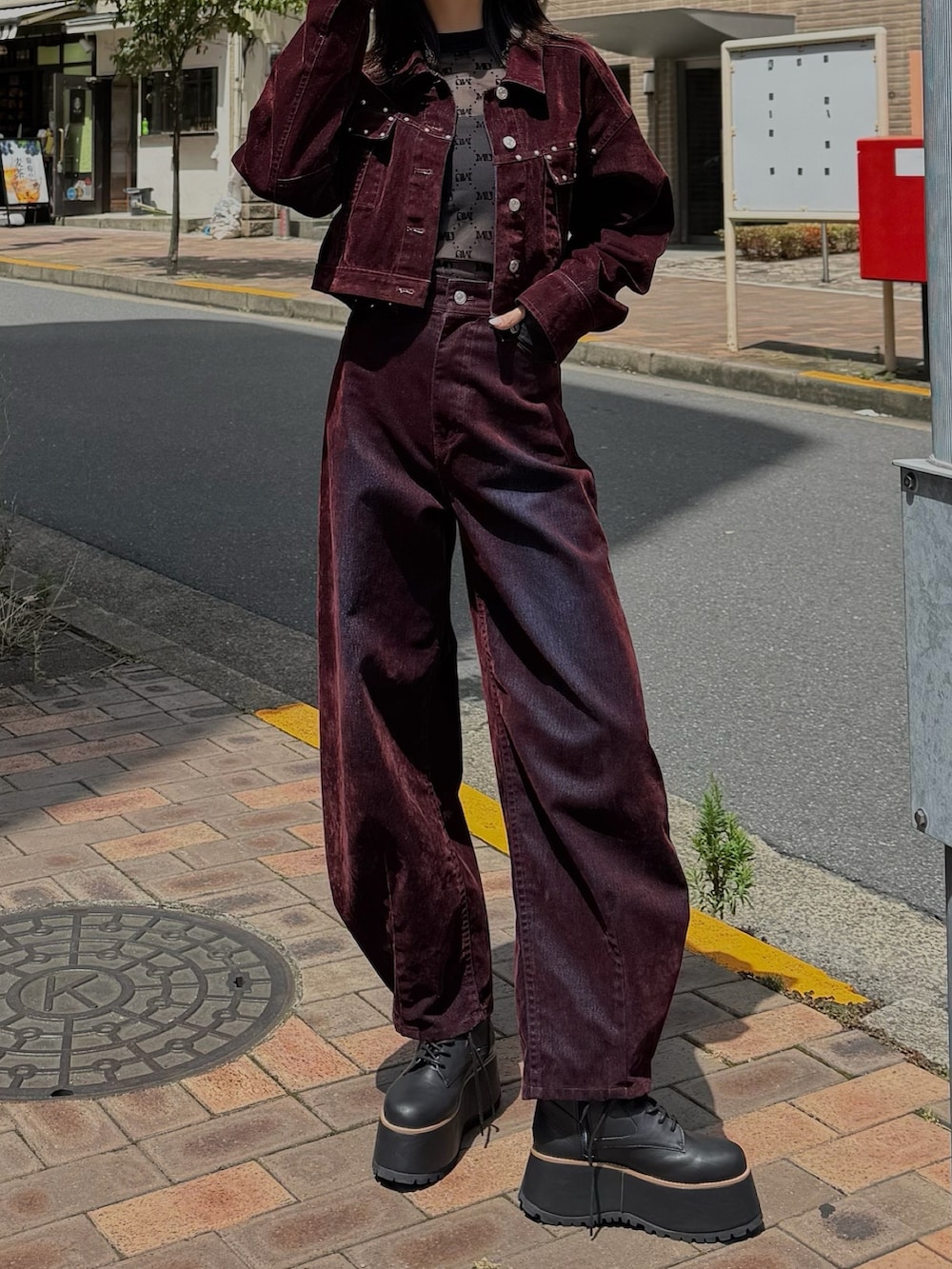 レッド系のデニムジャケット、レッド系のデニムパンツを着用したレディースの夏コーディネートの2枚目の写真