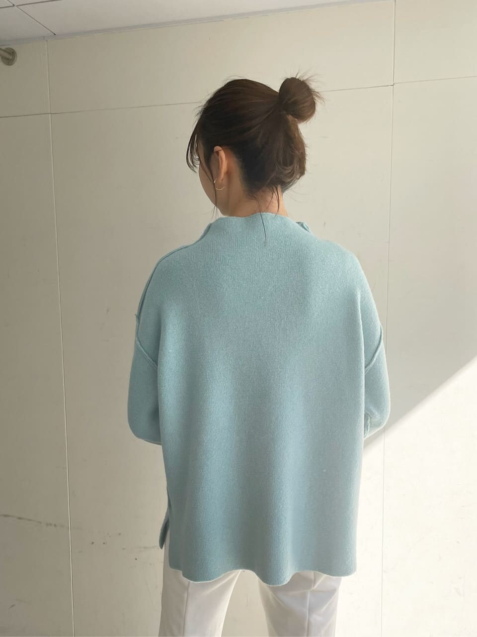 その他のハンドバッグ、ブラウン系のブーツ、ブルー系のニット/セーターを着用したレディースの冬コーディネートの3枚目の写真