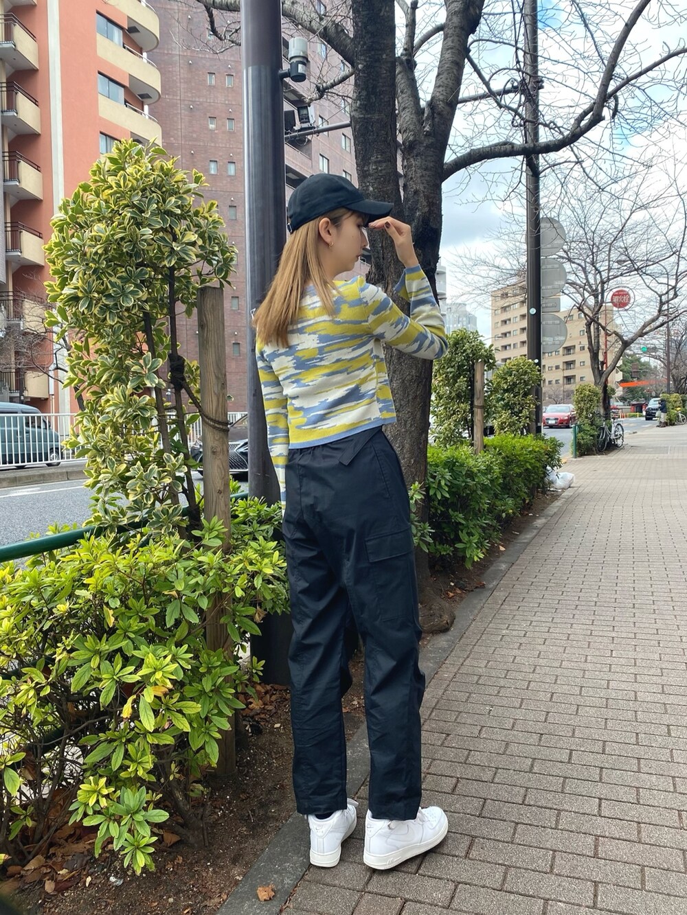 イエロー系のカーディガン/ボレロ、ホワイト系のハンドバッグ、ブラック系のカーゴパンツを着用したレディースの冬コーディネートの5枚目の写真