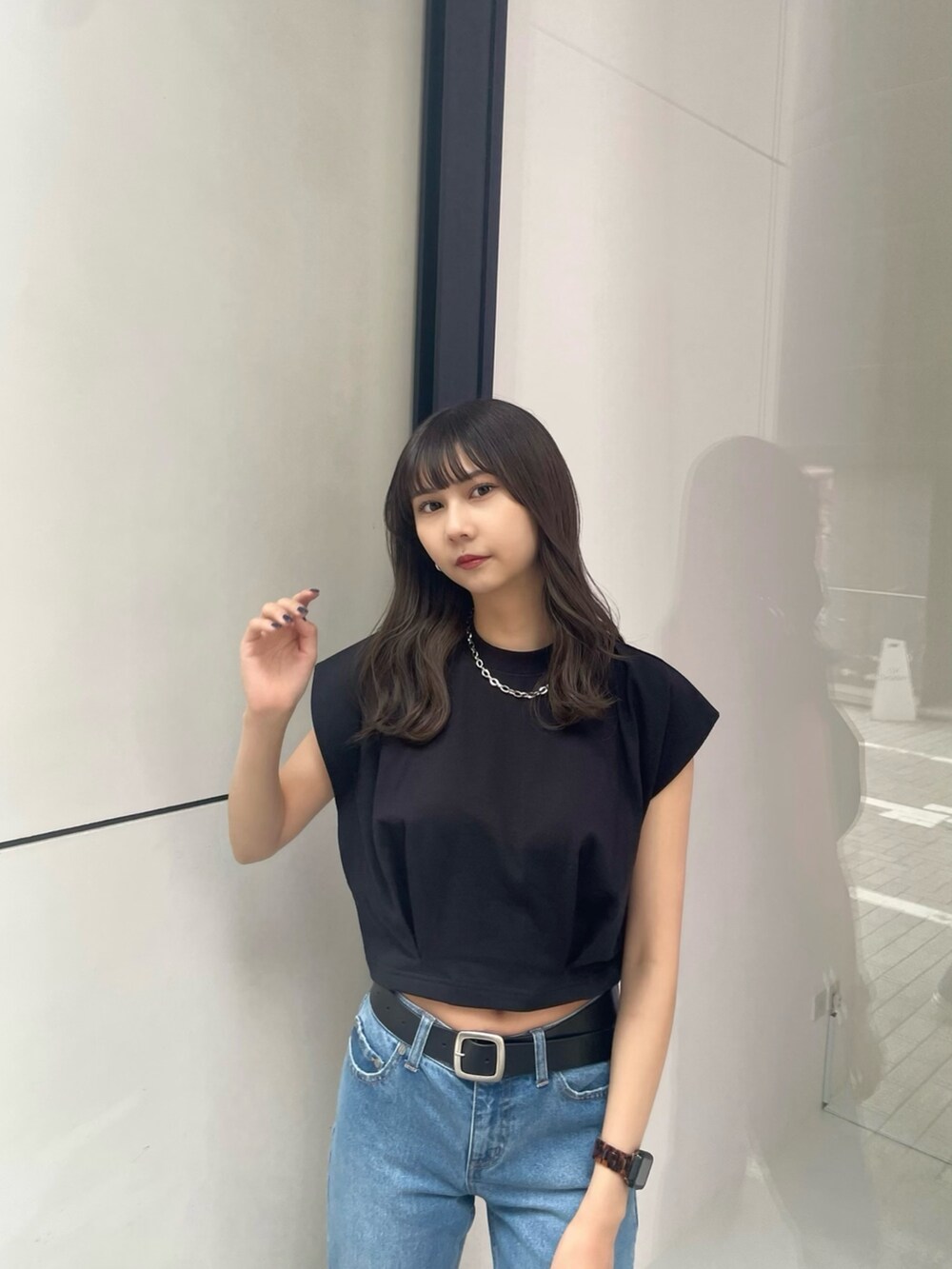 ブラック系のTシャツ/カットソー、ブルー系のデニムパンツ、ブラック系のサンダルを着用したレディースの春コーディネートの6枚目の写真