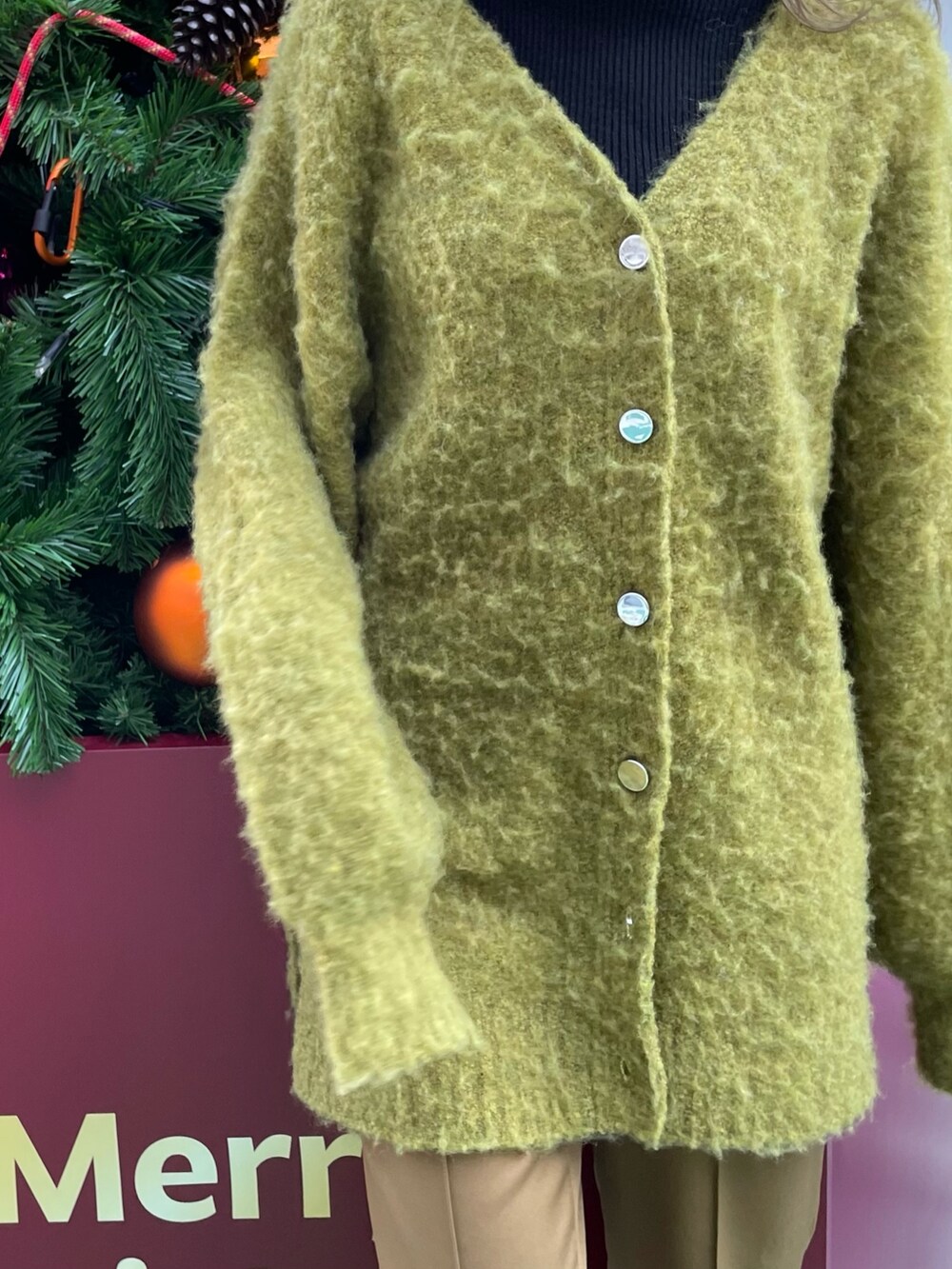 グリーン系のカーディガン/ボレロ、ブラック系のニット/セーター、ブラウン系のスウェットパンツを着用したレディースの冬コーディネートの6枚目の写真