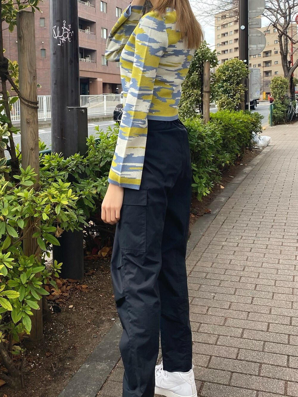 イエロー系のカーディガン/ボレロ、ホワイト系のハンドバッグ、ブラック系のカーゴパンツを着用したレディースの冬コーディネートの7枚目の写真