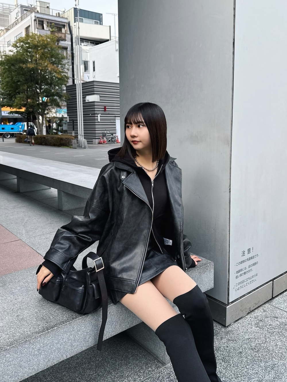 ブラック系のブルゾン、ブラック系のパーカー、ブラック系のブーツを着用したレディースの冬コーディネートの4枚目の写真