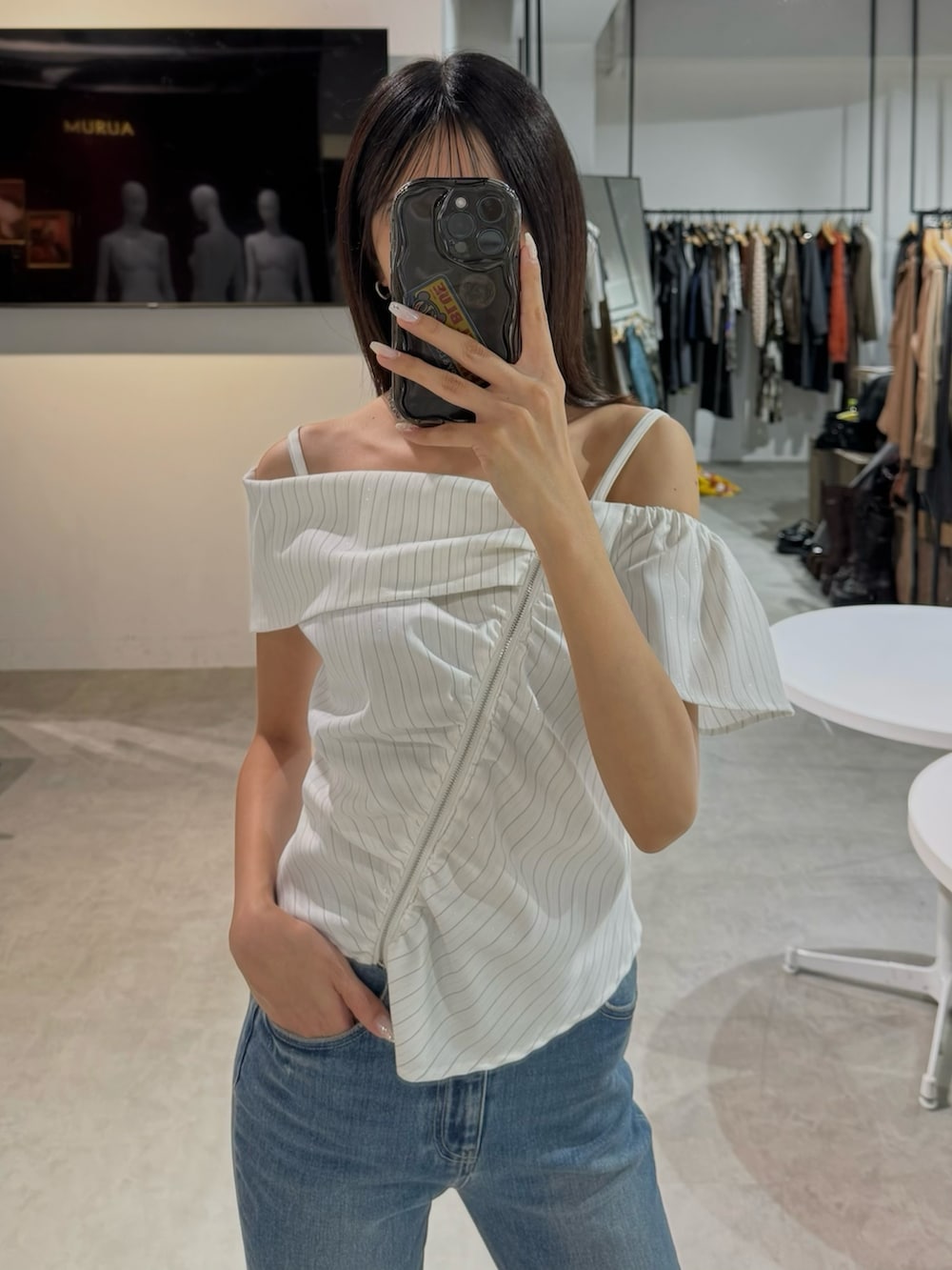 ホワイト系のシャツ/ブラウス、ブルー系のデニムパンツを着用したレディースの夏コーディネートの2枚目の写真