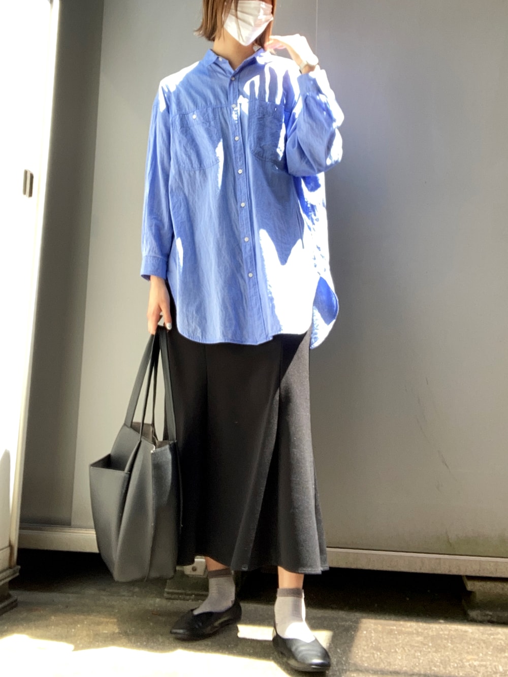 ブルー系のシャツ/ブラウス、ブラック系のスカートを着用したレディースの秋コーディネートの2枚目の写真