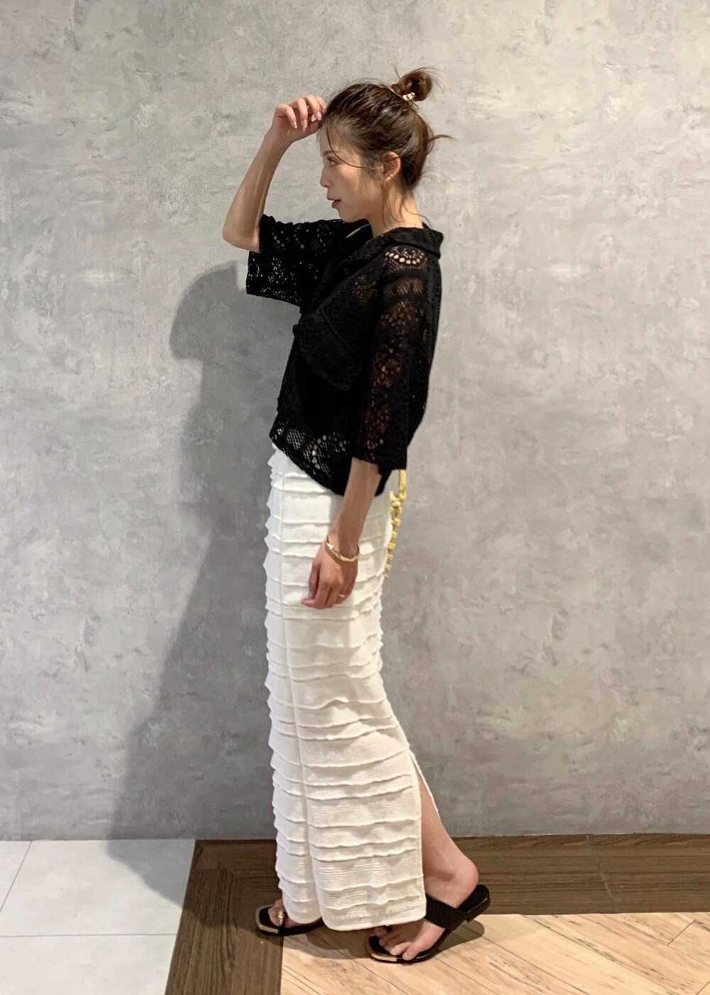 ブラック系のサンダル、ホワイト系のスカート、ブラック系のカーディガン/ボレロを着用したレディースの夏コーディネートの3枚目の写真