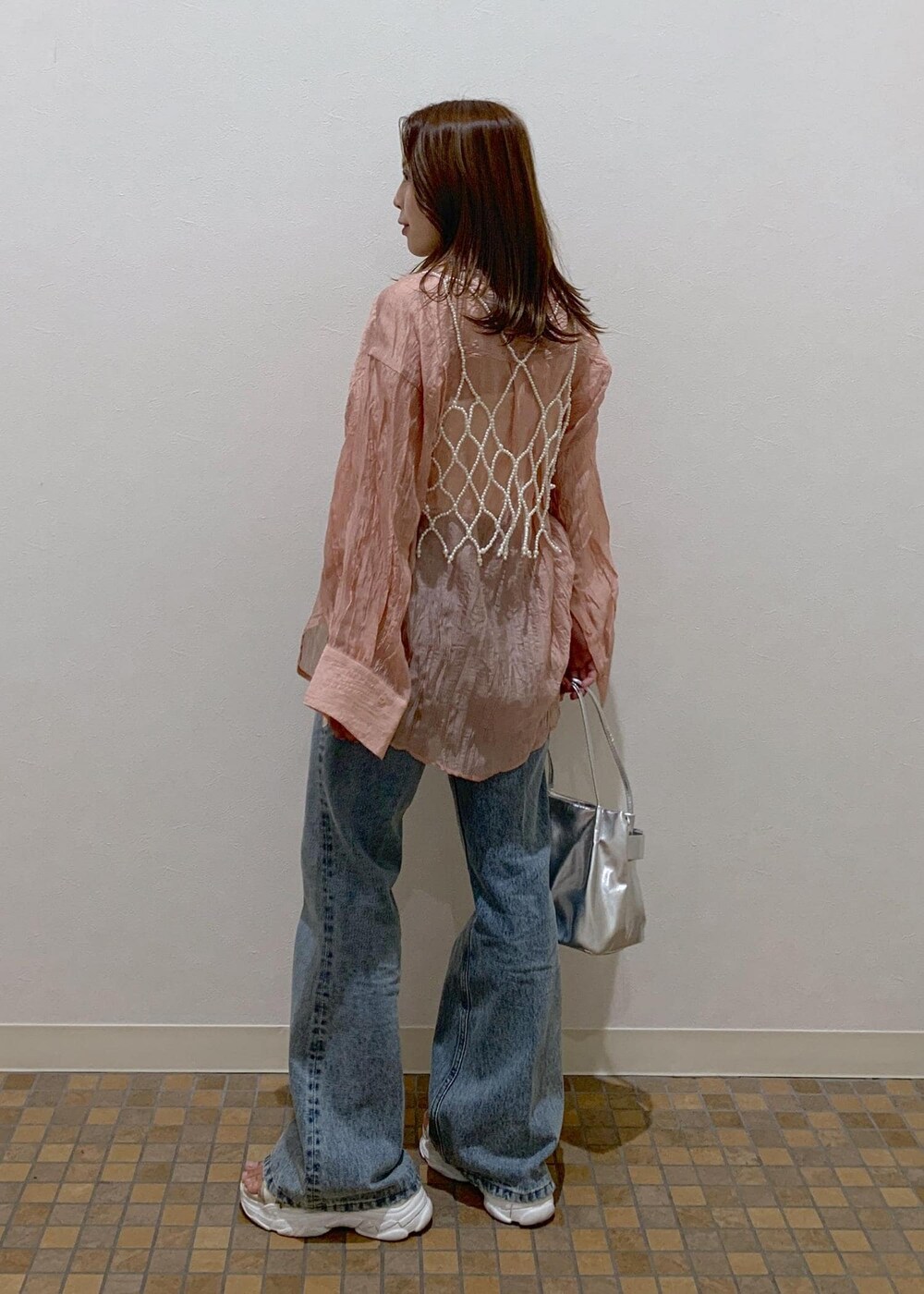 ピンク系のシャツ/ブラウス、ブルー系のデニムパンツ、シルバー系のショルダーバッグを着用したレディースの夏コーディネートの4枚目の写真