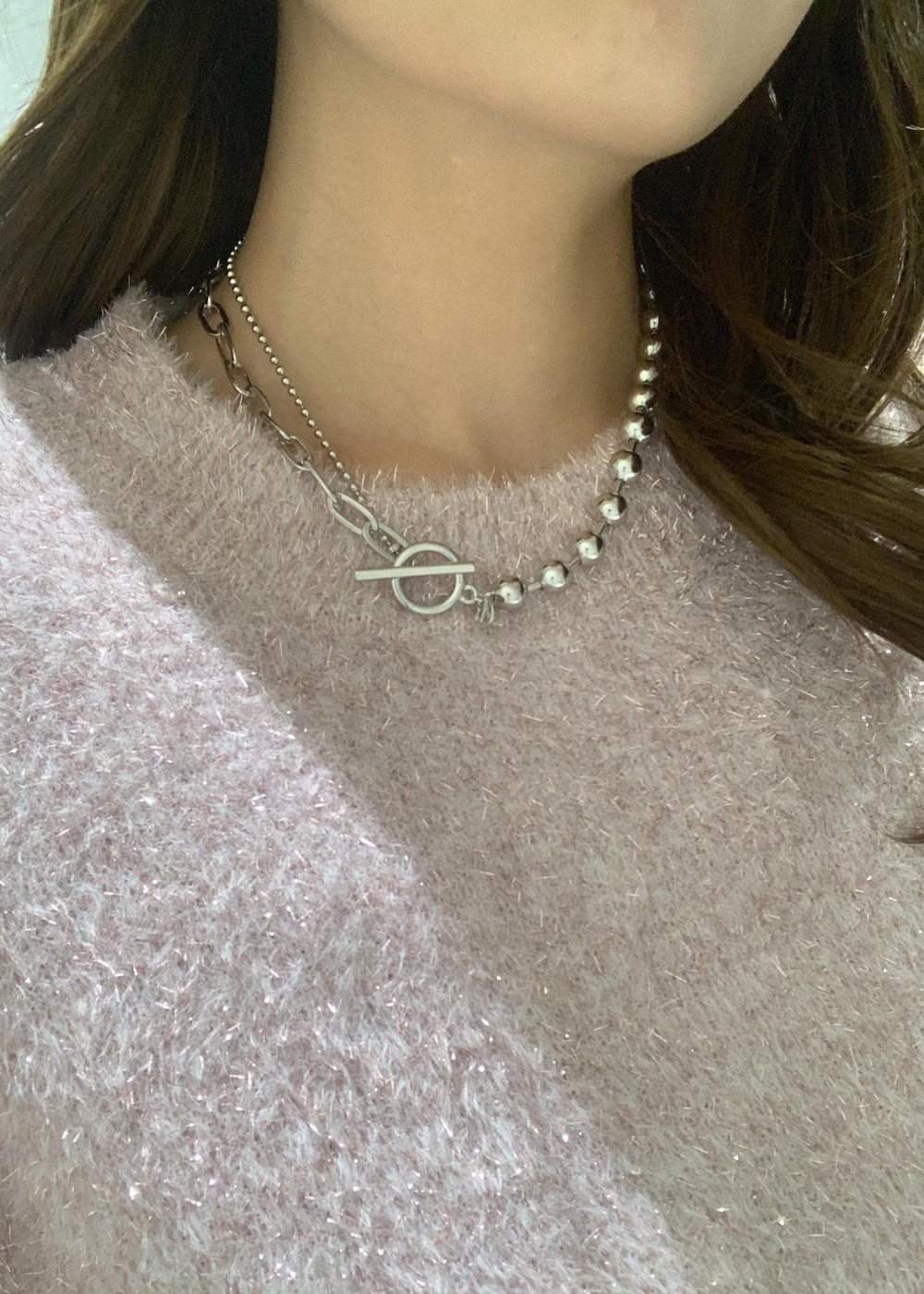 ピンク系のニット/セーター、ベージュ系のその他パンツ、ホワイト系のショルダーバッグを着用したレディースの冬コーディネートの9枚目の写真