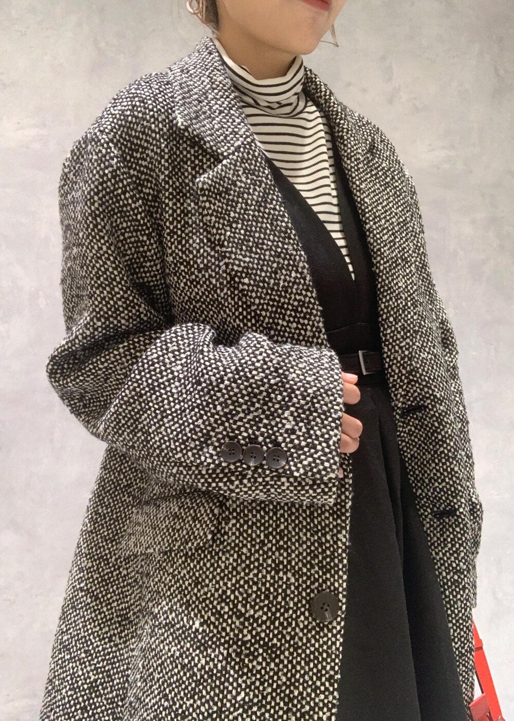 ブラック系のブーツ、レッド系のショルダーバッグ、ブラック系のワンピースを着用したレディースの冬コーディネートの10枚目の写真