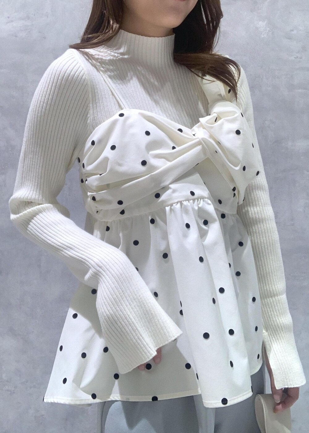 シルバー系のパンプス、ホワイト系のハンドバッグ、ホワイト系のニット/セーターを着用したレディースの冬コーディネートの8枚目の写真