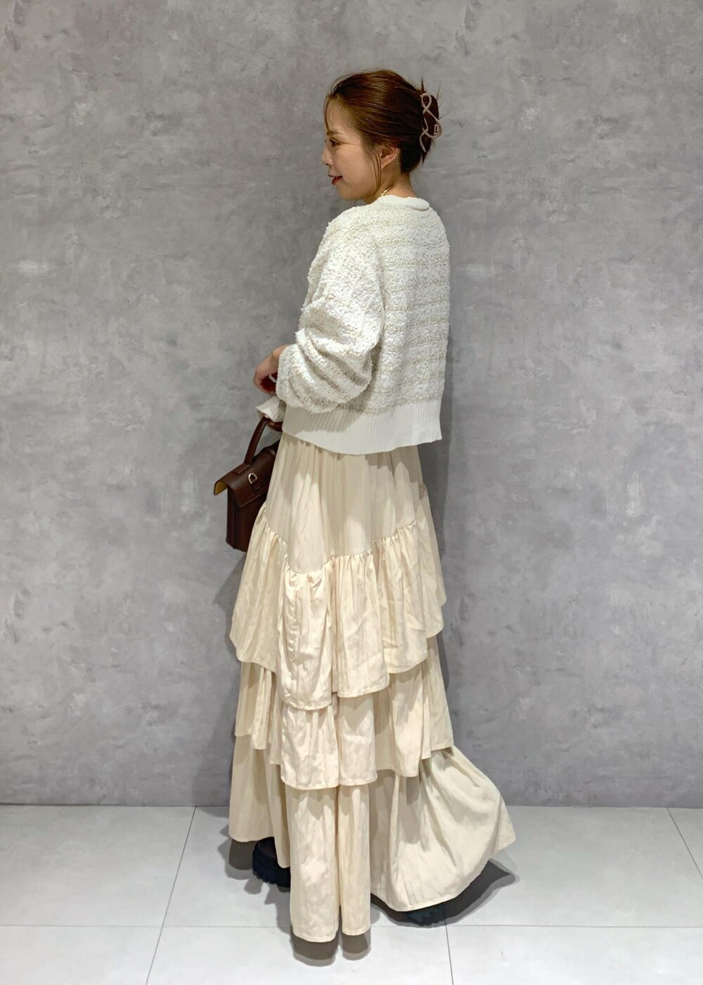 ブラウン系のショルダーバッグ、ブラウン系のブーツ、ホワイト系のカーディガン/ボレロを着用したレディースの夏コーディネートの4枚目の写真