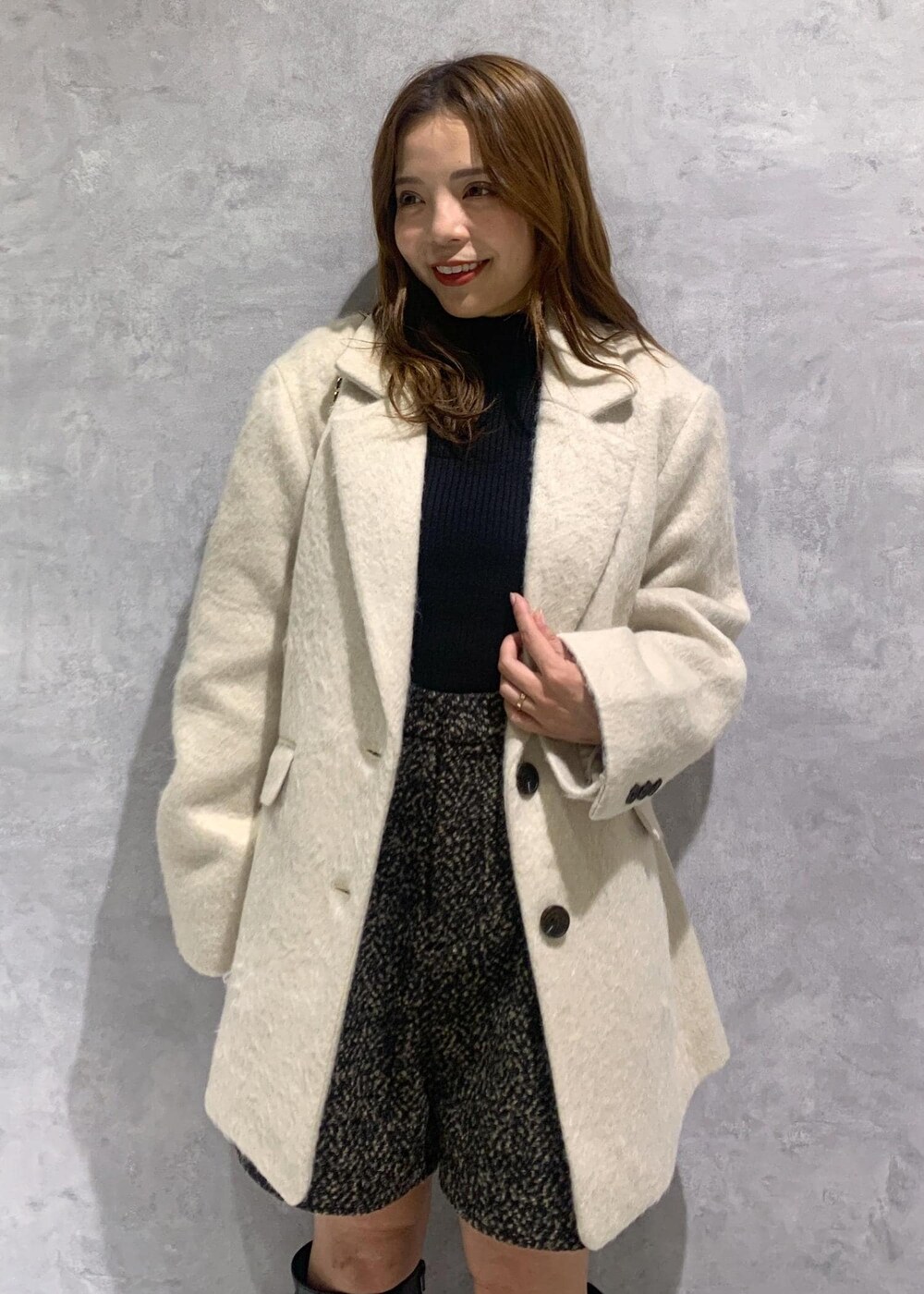 ブラック系のショルダーバッグ、ブラック系のブーツ、ブラック系のニット/セーターを着用したレディースの秋コーディネートの5枚目の写真