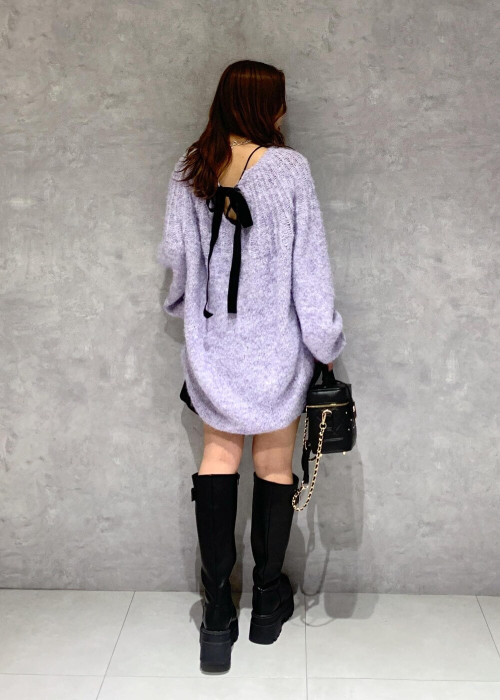 ブラック系のブーツ、パープル系のニット/セーター、ブラック系のその他パンツを着用したレディースの冬コーディネートの7枚目の写真