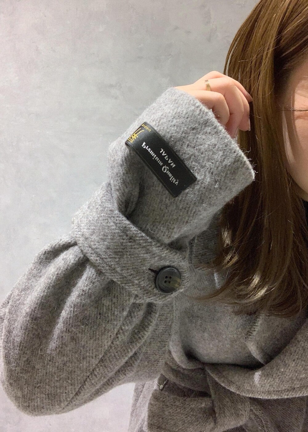 その他のショルダーバッグ、グレー系のステンカラーコート、ブラック系のワンピースを着用したレディースの秋コーディネートの7枚目の写真