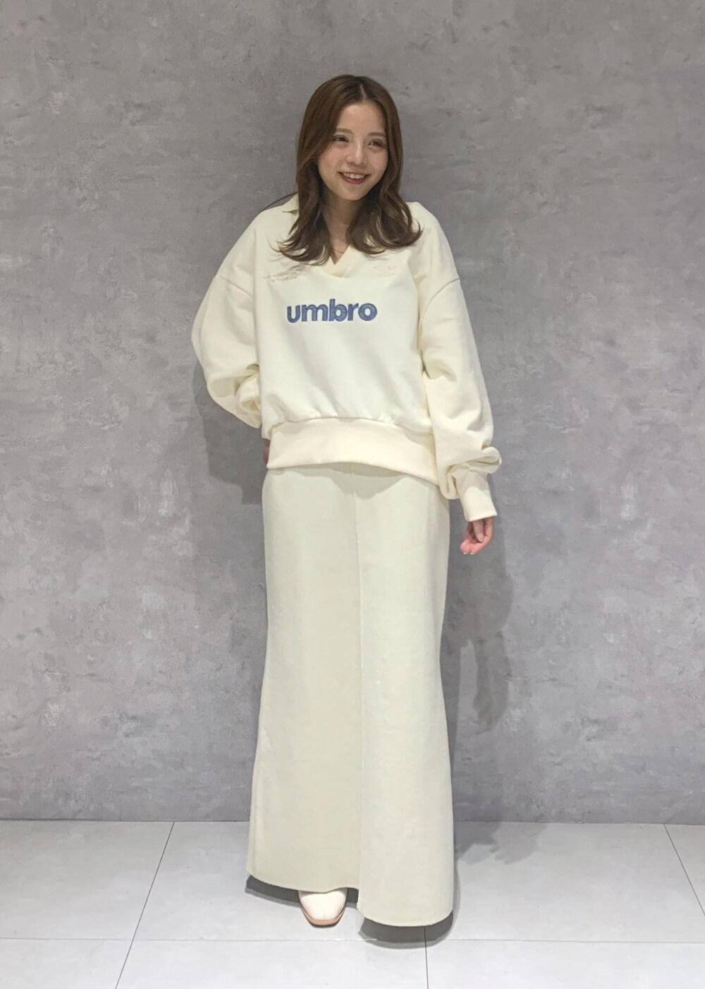 ホワイト系のブーツ、ホワイト系のスカート、ホワイト系のブルゾンを着用したレディースの秋コーディネートの7枚目の写真