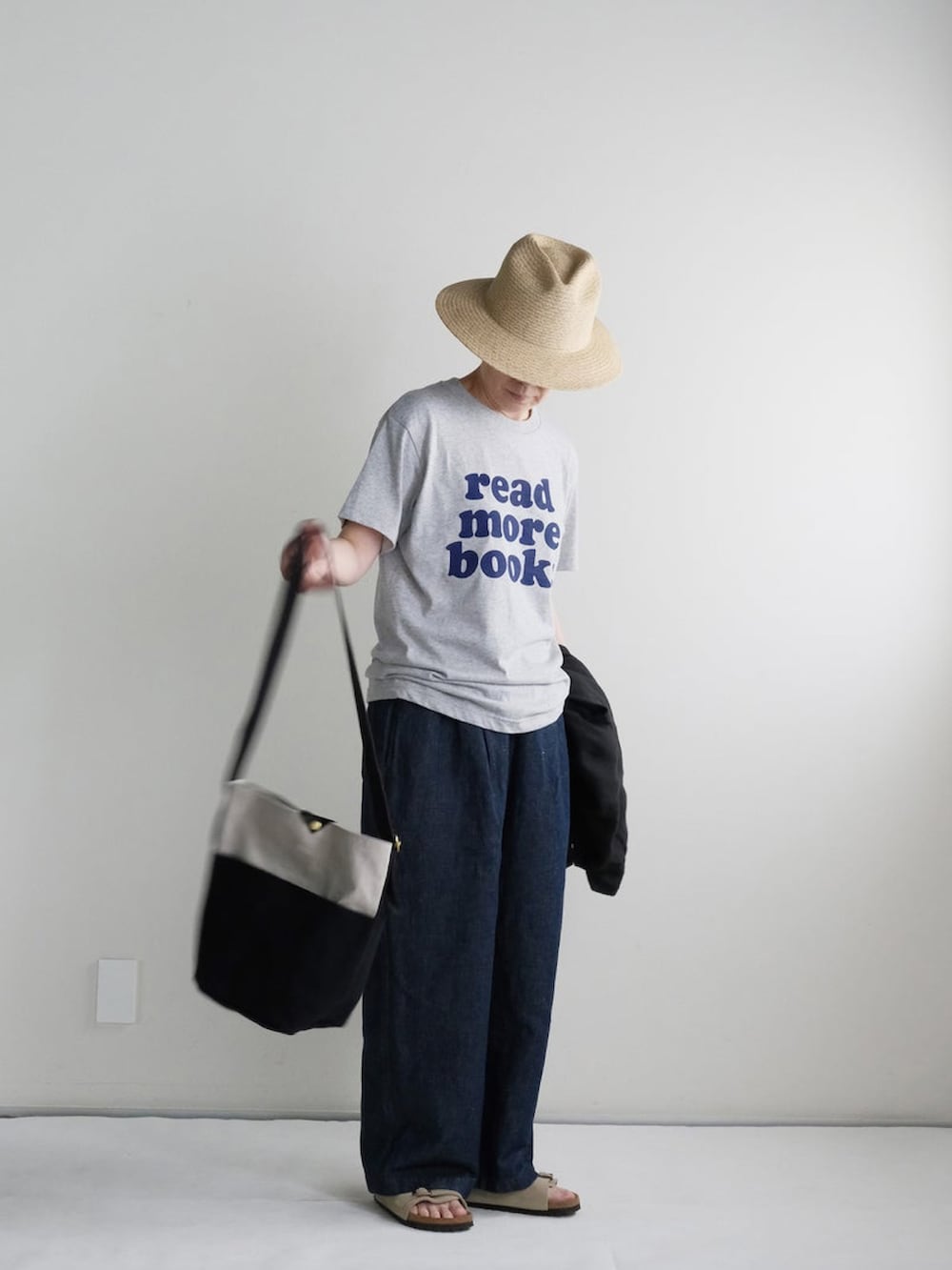 ブルー系のデニムパンツ、グレー系のTシャツ/カットソー、ブラウン系のサンダルを着用したレディースの夏コーディネートの2枚目の写真