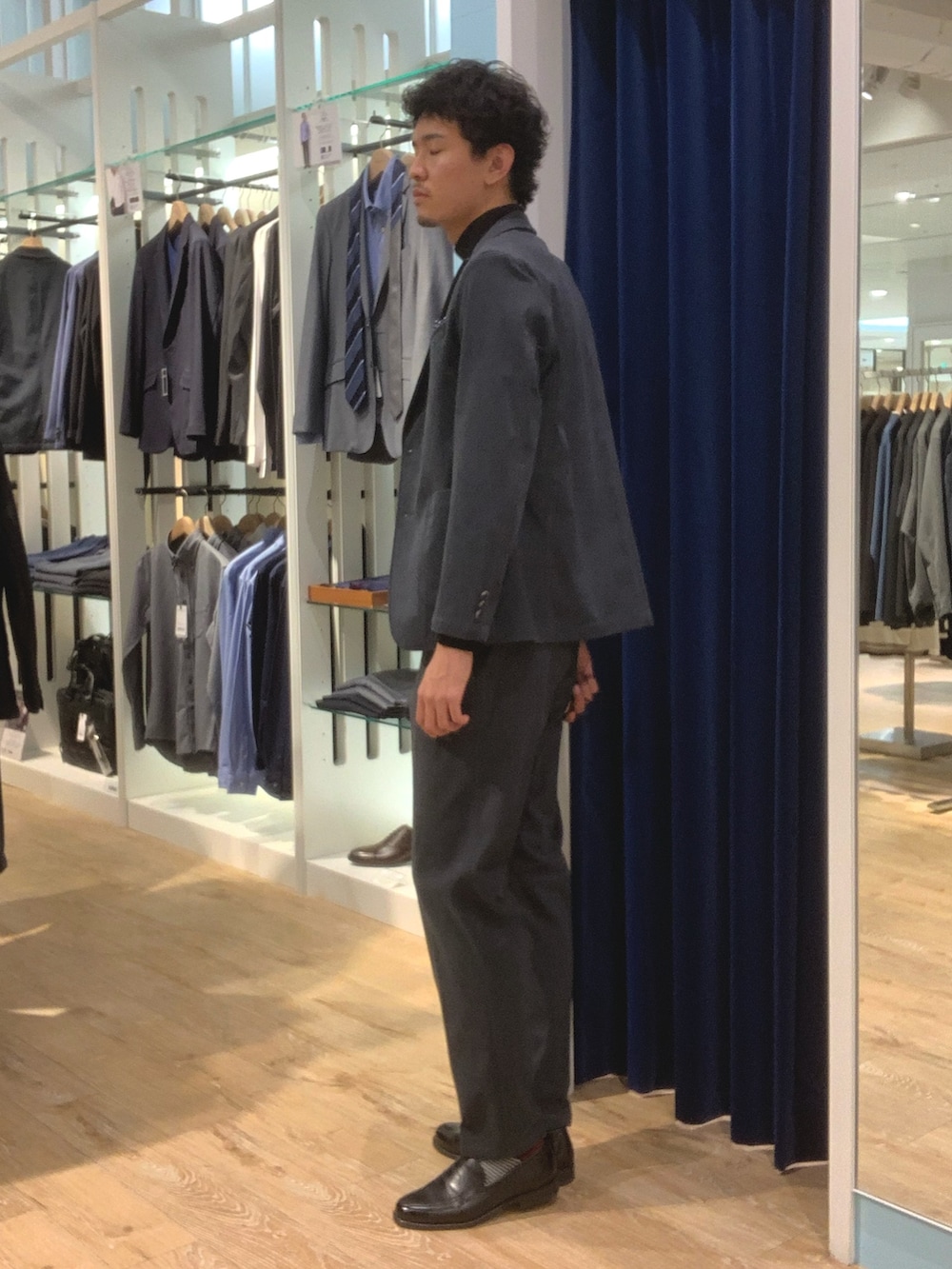 グレー系のテーラードジャケット、グレー系のその他パンツ、ブラック系のTシャツ/カットソーを着用したメンズの秋コーディネートの2枚目の写真