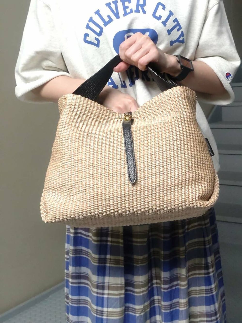 ベージュ系のスウェット、ブルー系のスカートを着用したレディースの春コーディネートの3枚目の写真