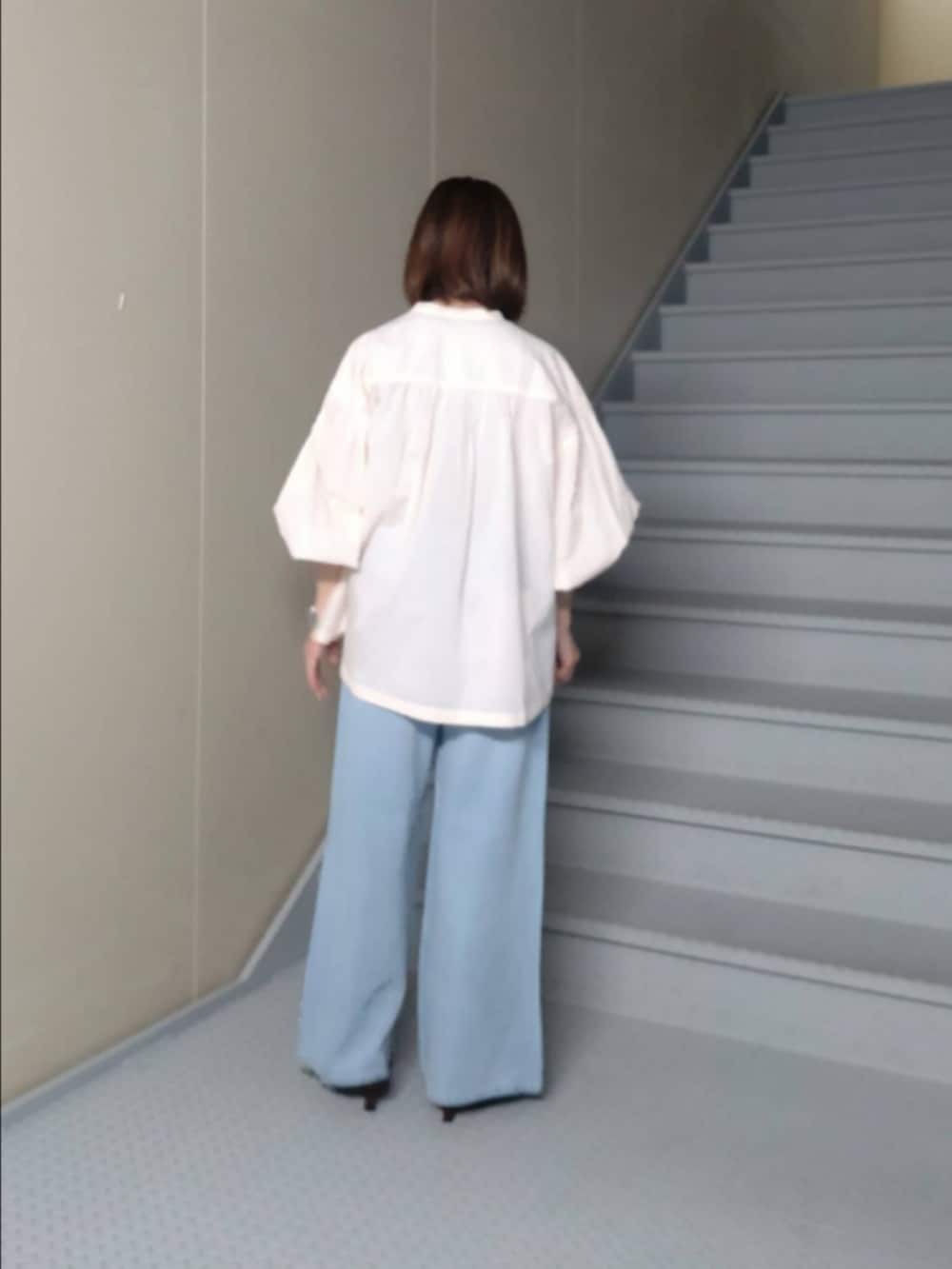 ピンク系のシャツ/ブラウス、ブルー系のデニムパンツ、ブラウン系のショルダーバッグを着用したレディースの春コーディネートの2枚目の写真