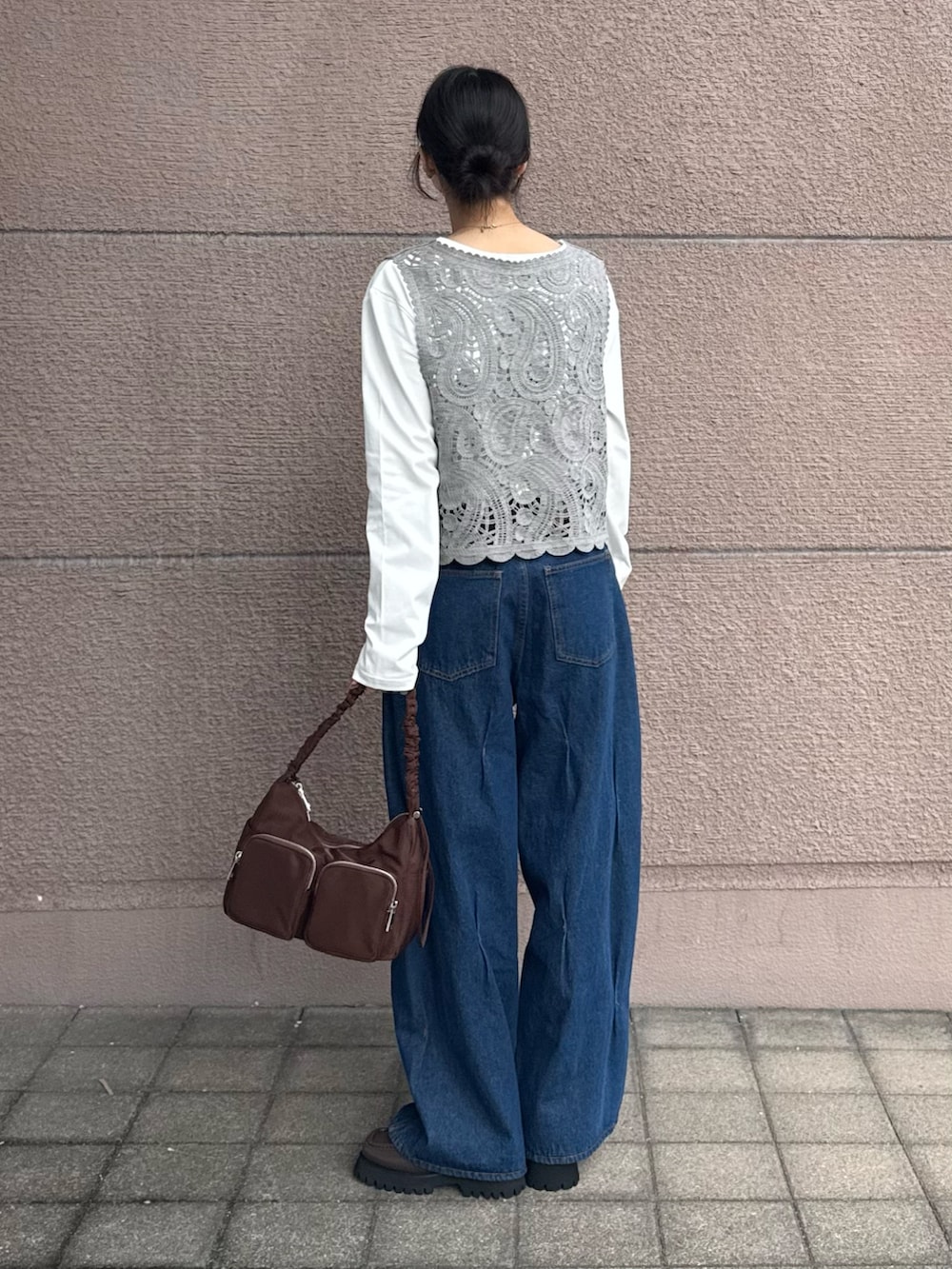 グレー系のTシャツ/カットソー、ブルー系のデニムパンツ、ブラウン系のショルダーバッグを着用したレディースの春コーディネートの2枚目の写真