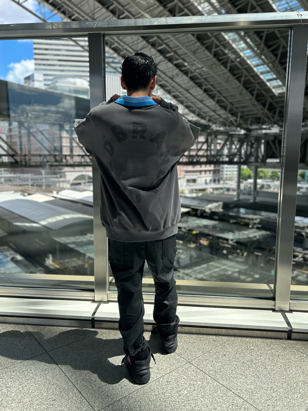 ブラック系のスウェット、ブラック系のカーゴパンツを着用したメンズの夏コーディネートの3枚目の写真