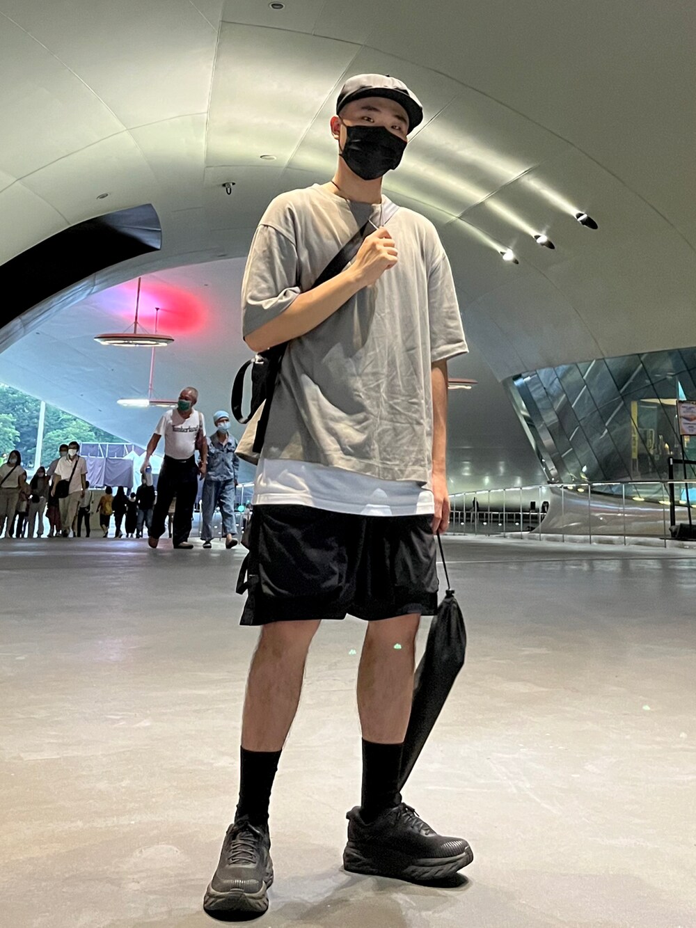 グレー系のTシャツ/カットソー、ブラック系のカーゴパンツ、ブラック系のスニーカーを着用したメンズの秋コーディネートの2枚目の写真