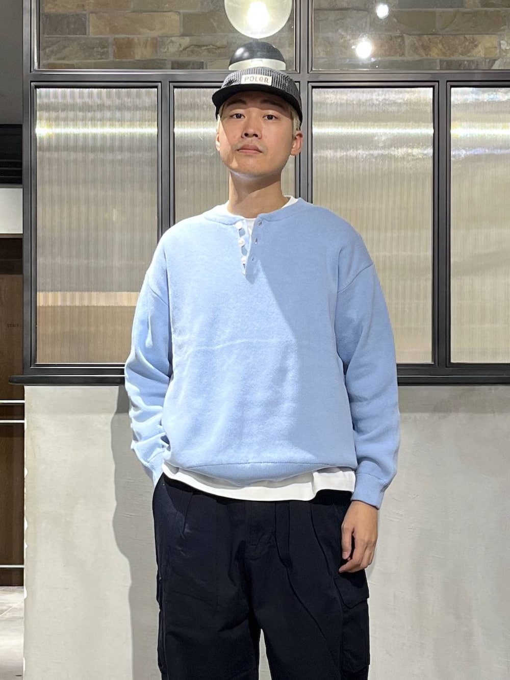 ブルー系のカーゴパンツ、ブルー系のニット/セーター、ホワイト系のTシャツ/カットソーを着用したメンズの冬コーディネートの4枚目の写真