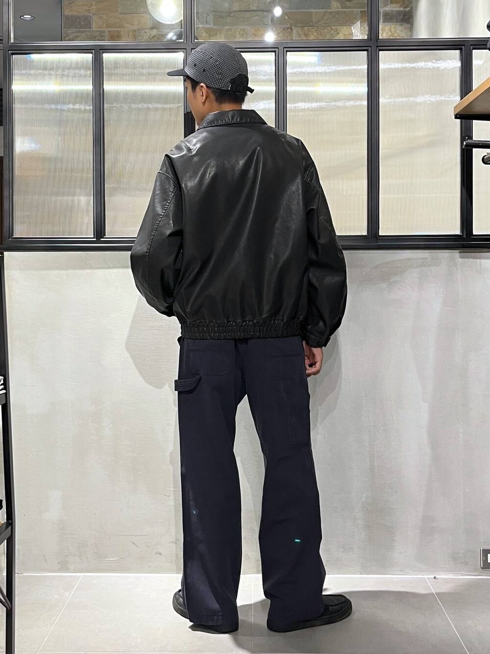 ブラック系のブルゾン、ブルー系のデニムパンツ、ピンク系のシャツ/ブラウスを着用したメンズの秋コーディネートの3枚目の写真