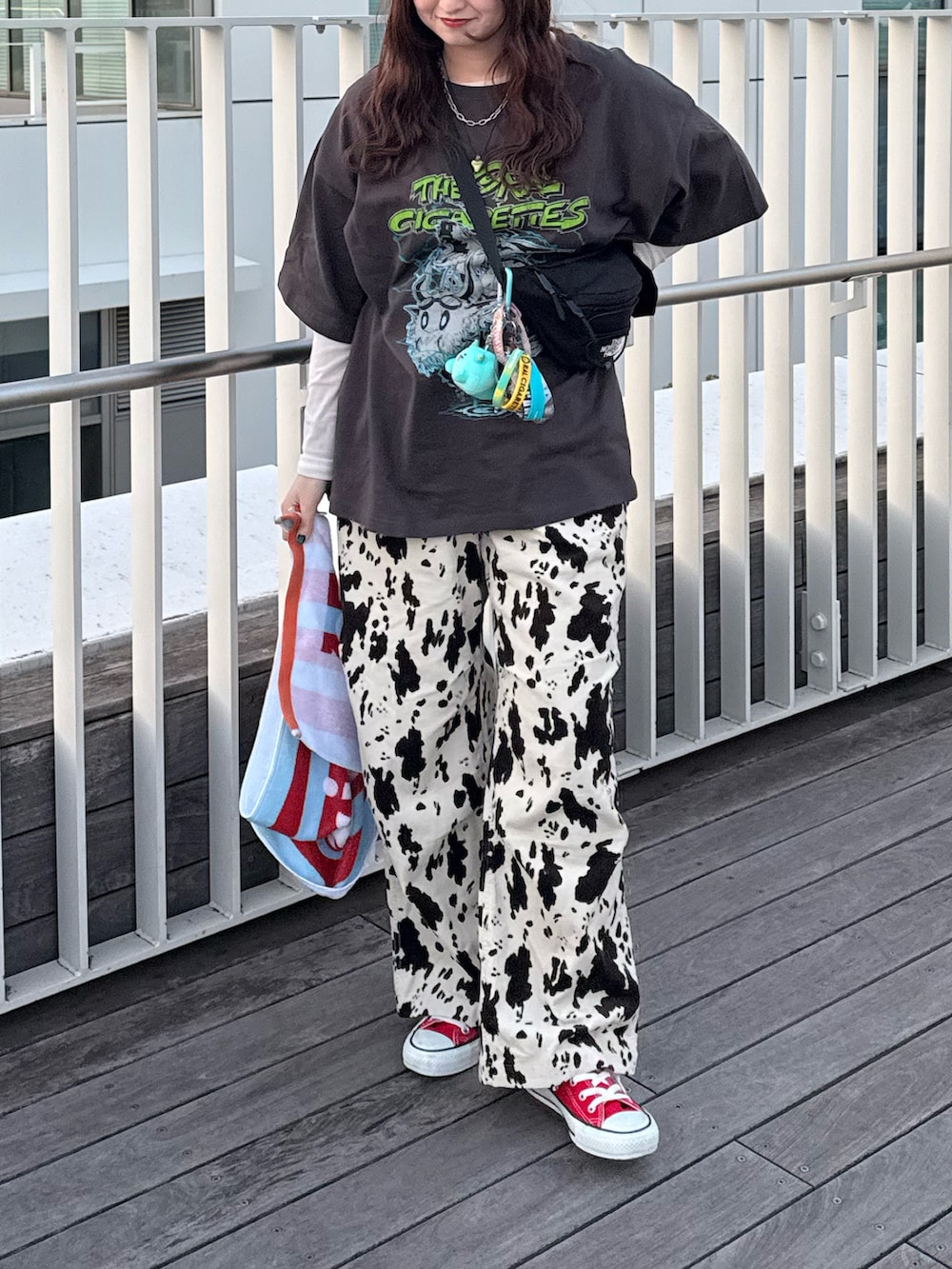 レッド系のスニーカー、ベージュ系のその他パンツ、ブラック系のボディバッグ/ウエストポーチを着用したレディースの春コーディネートの2枚目の写真